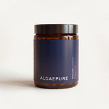 Amber glass jar with a black lid and a AlgaePure label on a cream background