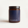 Amber glass jar with a black lid and a AlgaePure label on a cream background