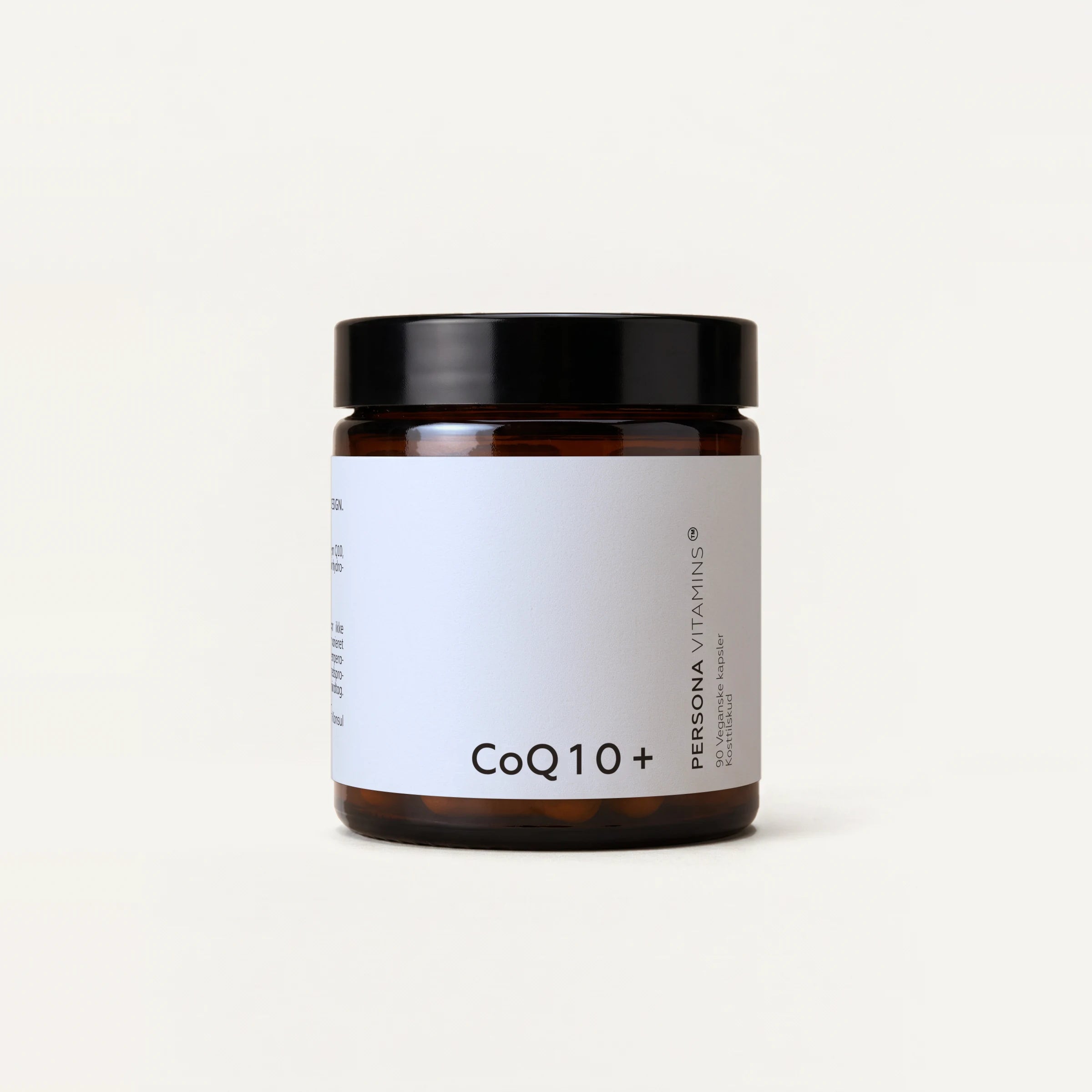 Amber glass jar with a black lid and a CoQ10+ label on a cream background