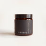 Amber glass jar with a black lid and a dark Probio label on a cream background, straight-on view