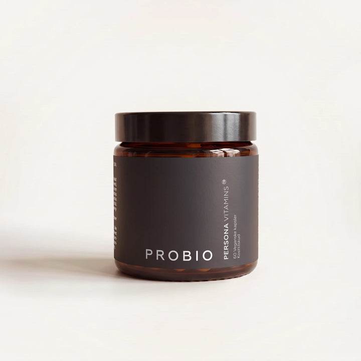 Amber glass jar with a black lid and a dark Probio label on a cream background, straight-on view