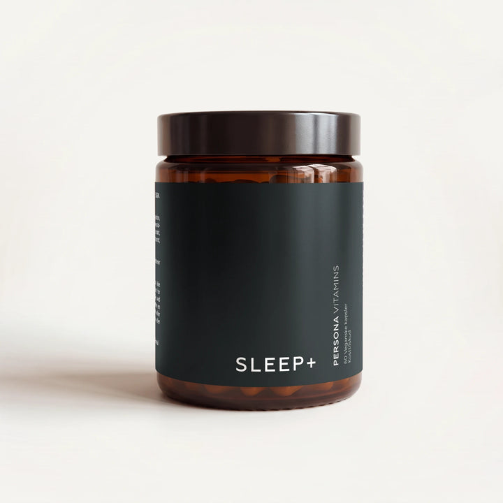 Amber glass jar with a black lid and a Sleep+ label on a cream background